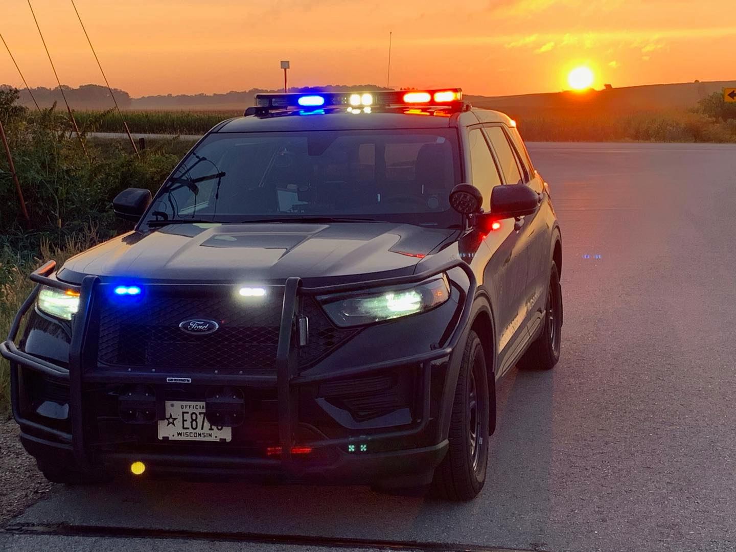 A police car parked in front of a sunset A police car parked in front of a sunset