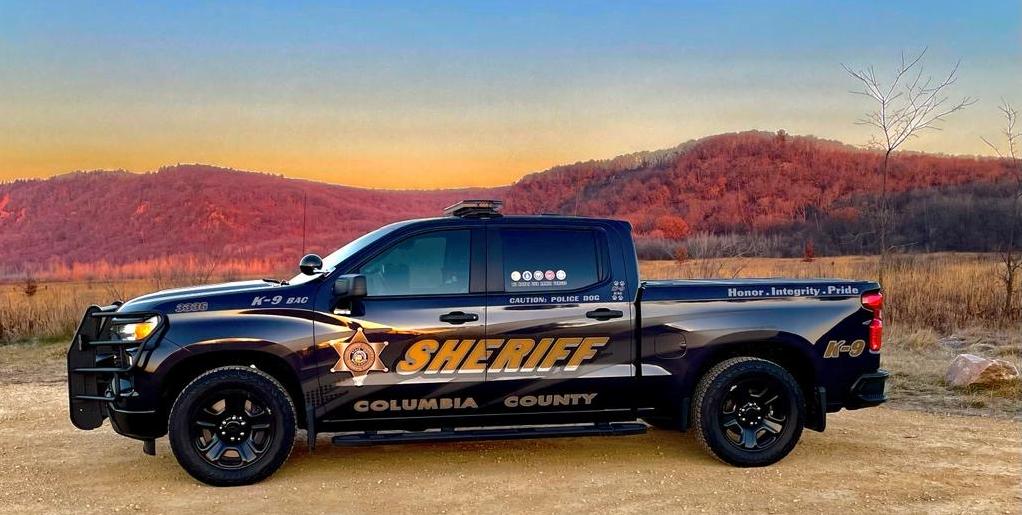 Photograph of a Columbia County squad vehicle with a scenic backdrop